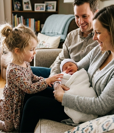 Young sibling meeting their new baby brother or sister